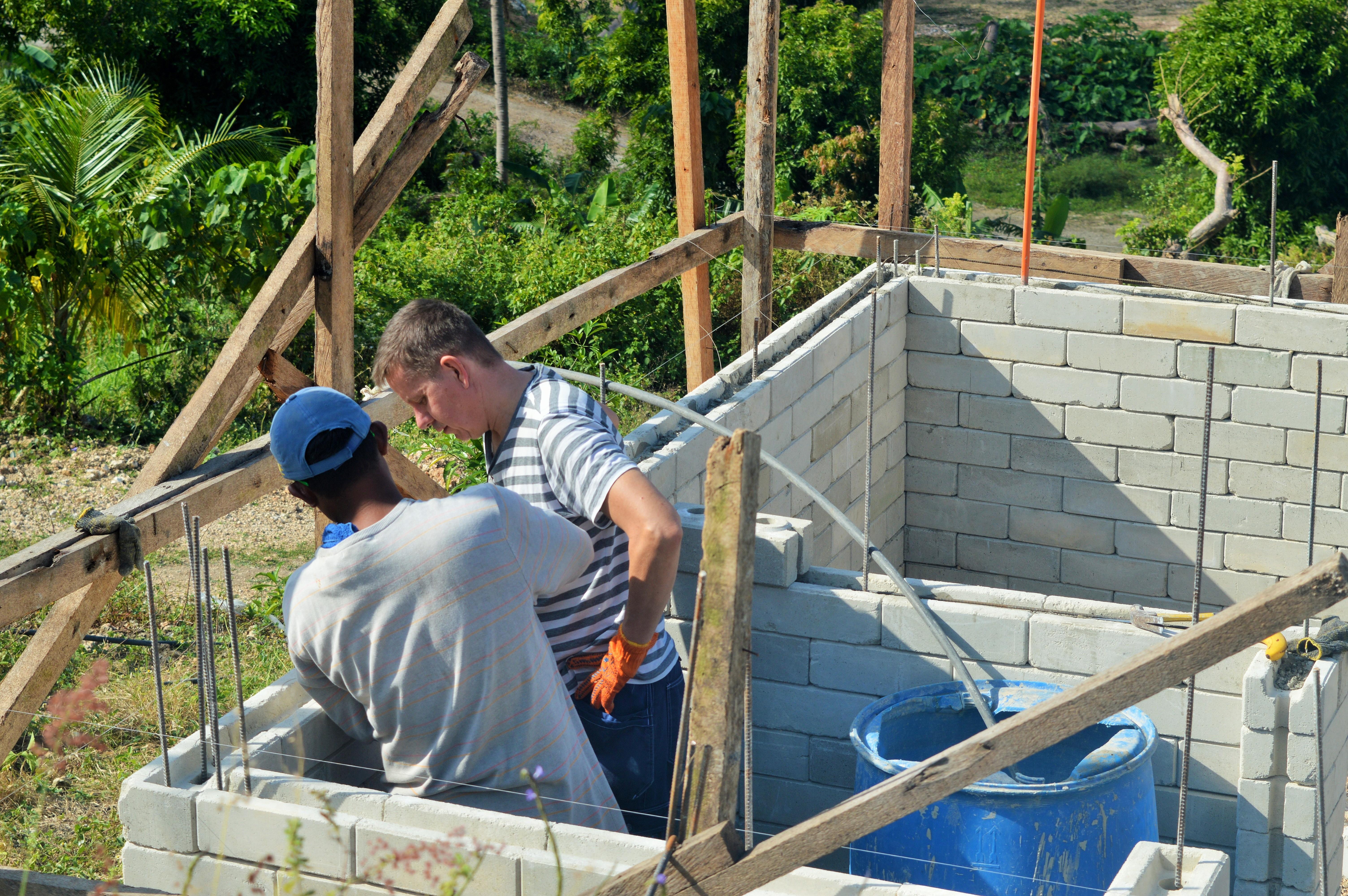 A Projects Abroad volunteer is pictured with a local builder whilst rebuilding homes and schools as part of a disaster relief project during his building volunteer work in the Phillippines. Projects Abroad volunteer is pictured with a local building helping to rebuild homes and schools as part of a disaster relief project during his building volunteer work in the Phillippines.